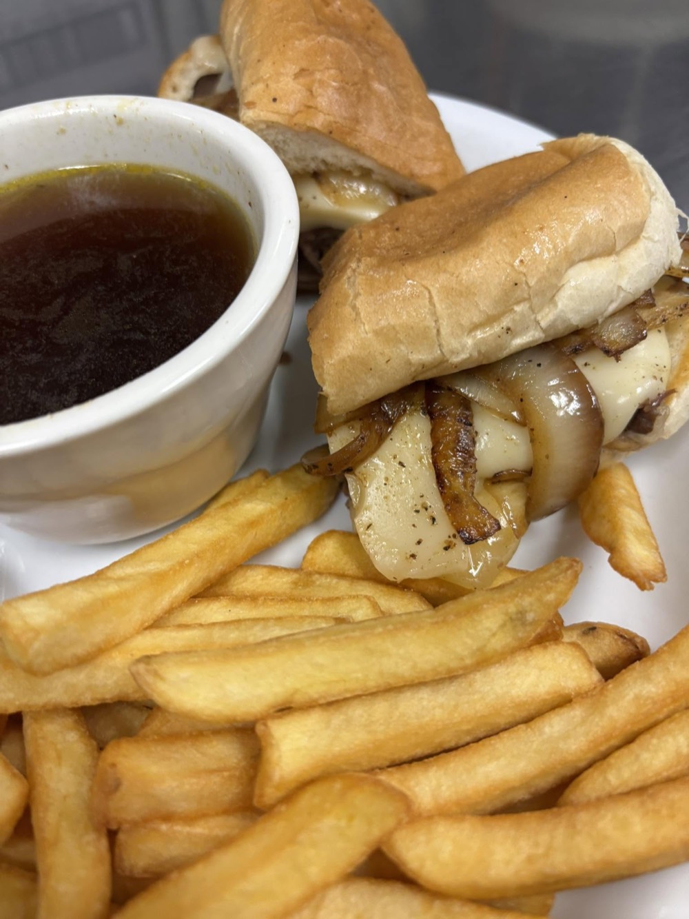 French dip sandwich with fries and au jus