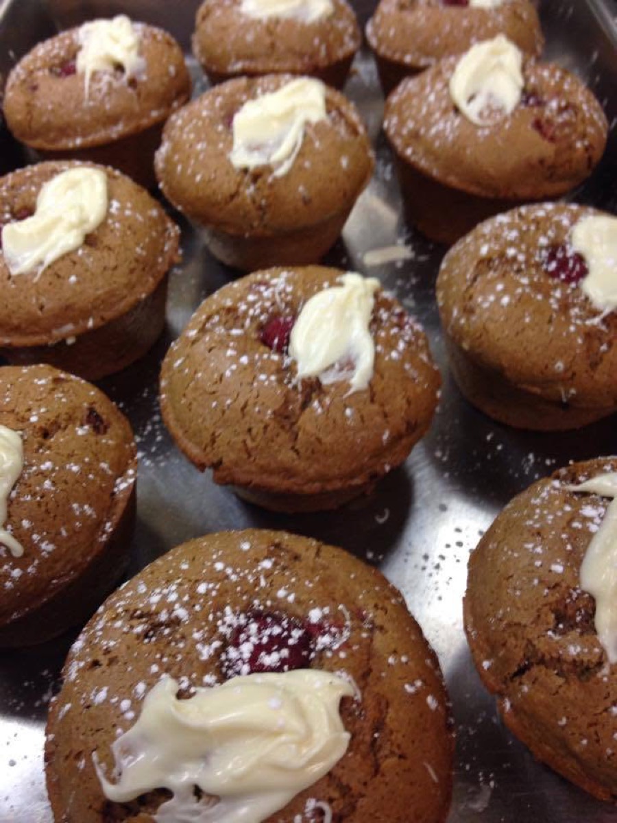 Tray of homemade muffins dusted with powdered sugar
