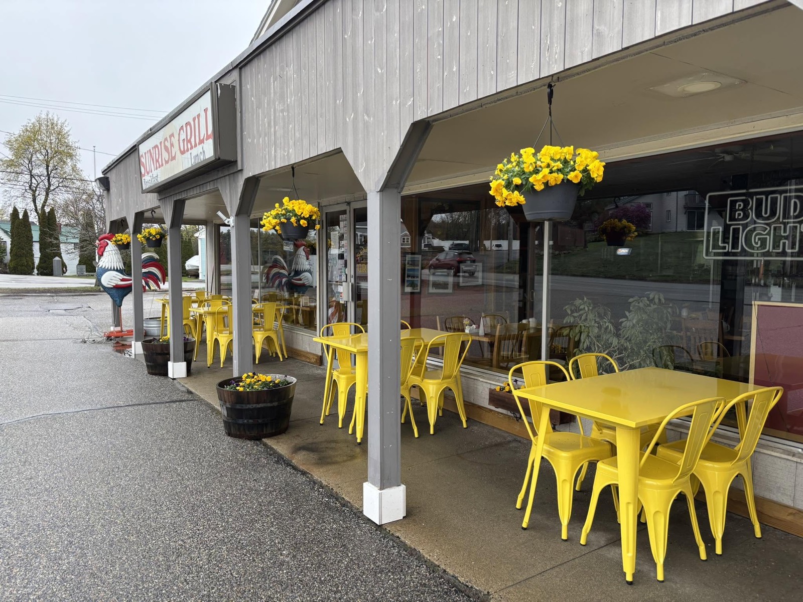 Sunrise Grill's cheerful patio with yellow tables and flowers